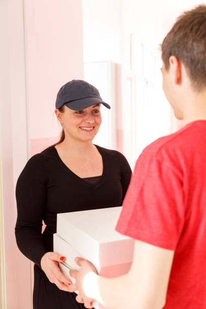 istock Young woman delivers pizza 671054228