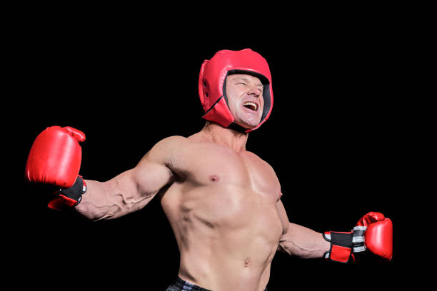 istock Boxer with arms outstretched against black background 671054466