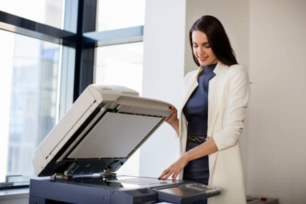 istock Woman in office scaning paper 671074314