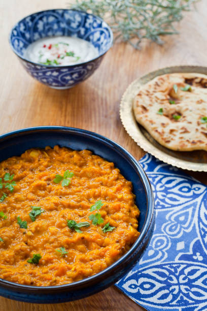 istock Red Lentils Dal with tomatoes and fesh chili garnish. 671075032