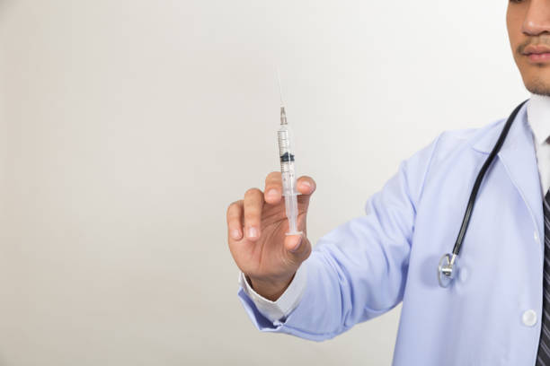 istock Doctor with syringe is preparing for medical injection 671084408