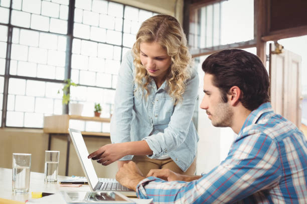 istock Woman pointing at laptop in office 671092448