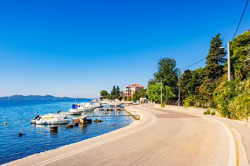 Stock photograph of winding road and docked boats along the Adriatic Sea coastline in the city of Zadar, Croatia, Europe.