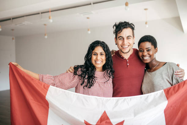 istock Students holding Canadian flag 671094960