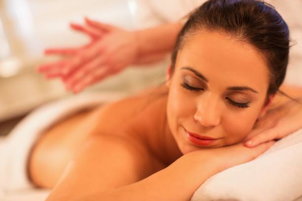 istock Happy young woman having back massage 671100726