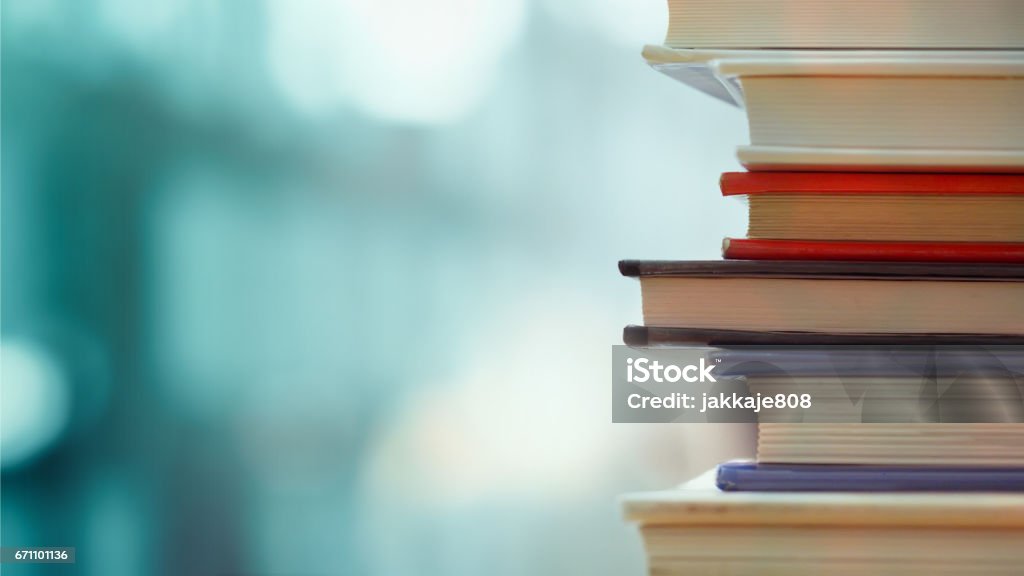 Business and education background Book stack in the library room and blurred bookshelf, business and education background Book Stock Photo