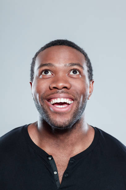 istock Cheerful young african man looking away 671104900