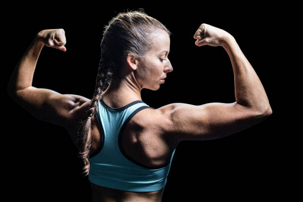 istock Athlete woman flexing muscles 671117756