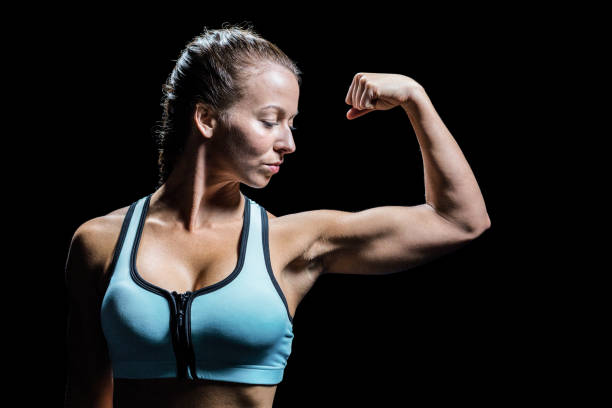 istock Fit woman flexing muscles 671117928
