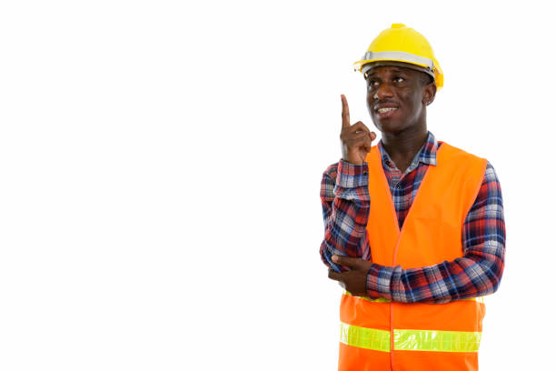 istock Studio shot of young happy black African man construction worker smiling and thinking while pointing finger up 671124814