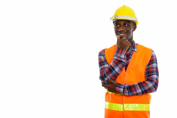 istock Studio shot of young happy black African man construction worker smiling and thinking while looking up 671124818