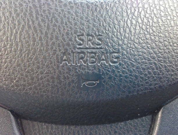 istock Driving wheel with srs airbag sign closeup 671130326