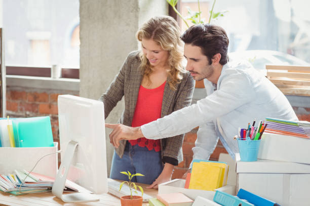 istock Businessman pointing towards computer in office 671136914