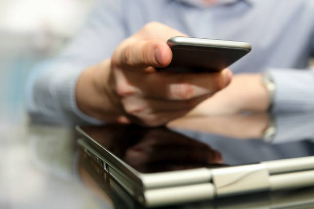 istock Business man working and analyzing financial figures on a graphs using laptop and mobile phone 671143590