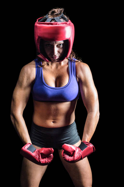 istock Portrait of female boxer flexing muscles 671149410