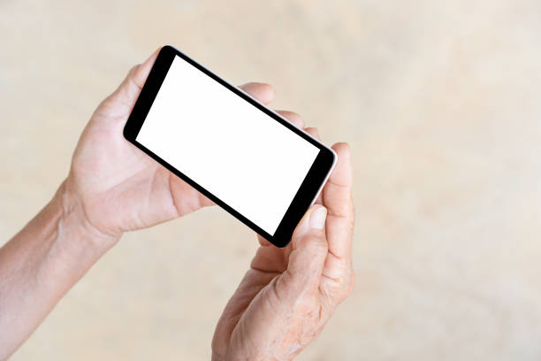 istock older person, hand holding and touch smart phone 671149684