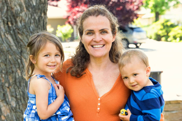 Mature woman posing with her children