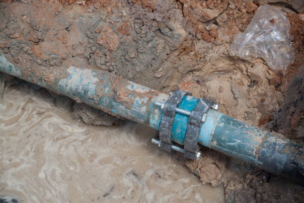 istock repair the plumbing broken pipe and water flow in hole. 671152798