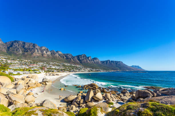 Clifton beach without people at noon A wide picture of Clifton Beach in Cape Town, South Africa at noon with wave and without people and with the Twelve Apostles in the background. Colorful and satured taken with a Canon 6D. clifton stock pictures, royalty-free photos & images