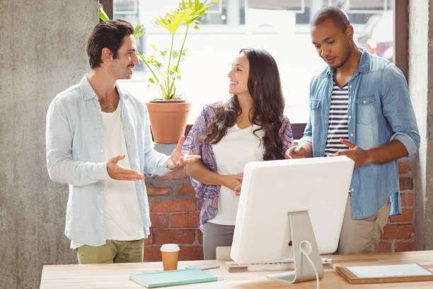 istock Business people discussing while standing in office 671159696