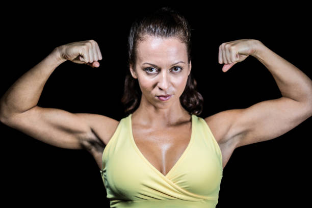 istock Portrait of confident athlete flexing muscles 671160694
