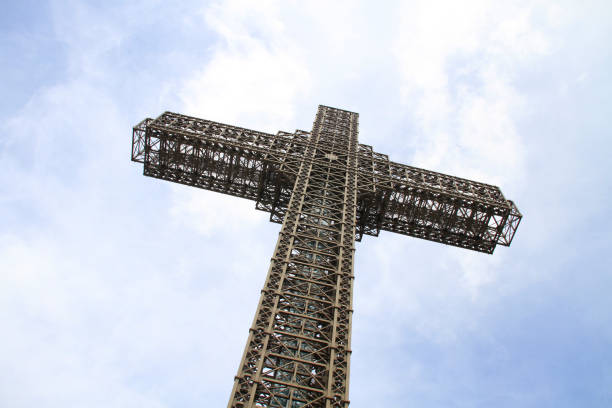 The religious cross next to the city building.