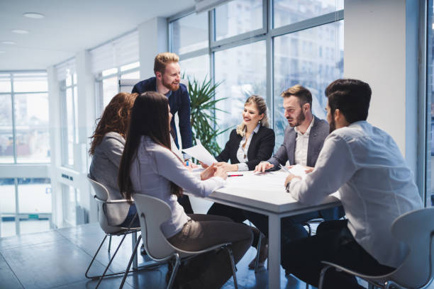 istock Group of business people collaborating on project  in office 671180038