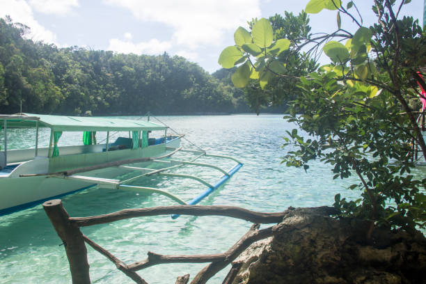 istock beach view with boat and clear aqua blue waters 671184662