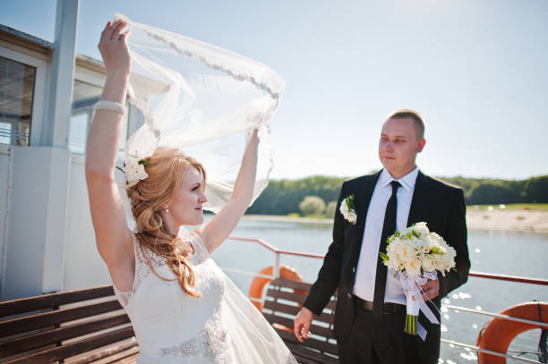 istock wedding couple on small boat ship 671193408