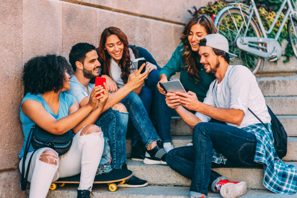 istock Friends browsing the net outdoors 671196706