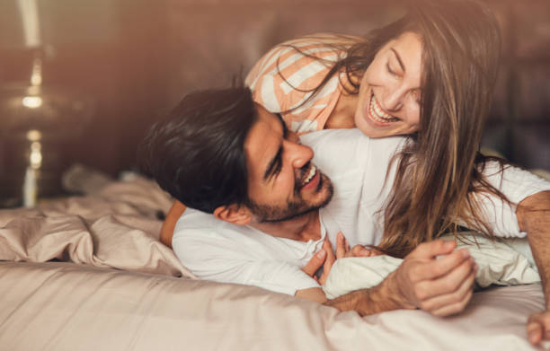 istock Happy young couple in bed 671196720