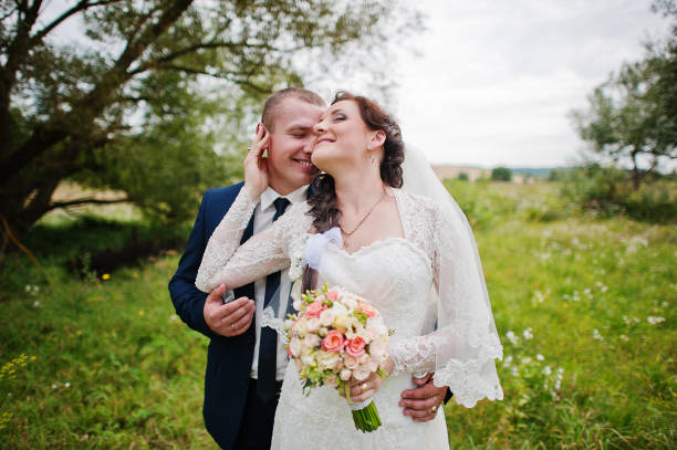 istock Wedding couple in high grass and near tree 671197078