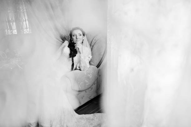istock Brunette bride siting on chair 671197102