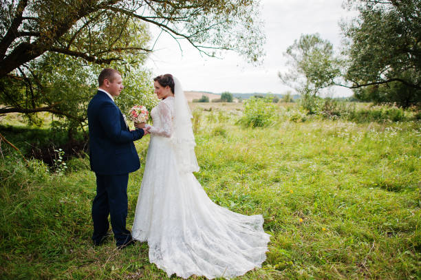 istock Wedding couple in high grass and near tree 671197320