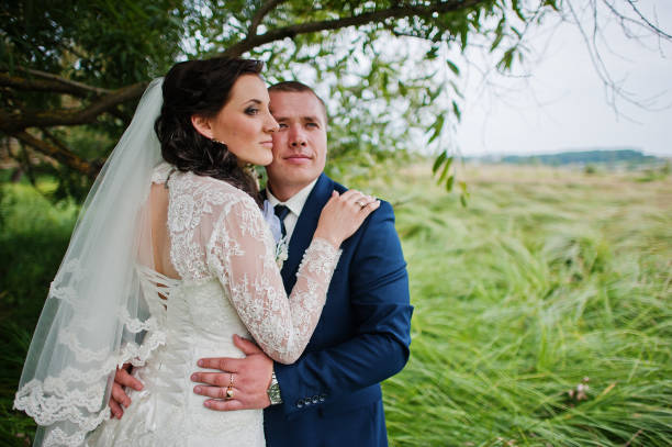 istock Wedding couple in high grass and near tree 671197764