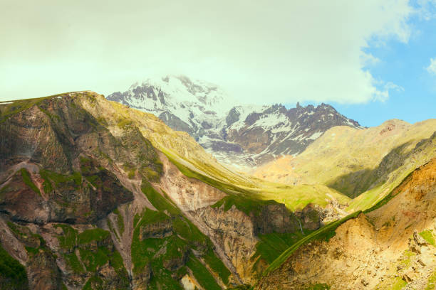 istock Fantastic mountain landscape with green meadows 671199472