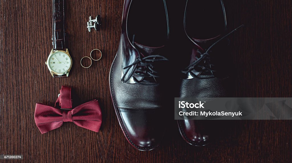 https://media.istockphoto.com/id/671200274/photo/close-up-of-modern-man-accessories-wedding-rings-cherry-bowtie-leather-shoes-watch-and.jpg?s=1024x1024&w=is&k=20&c=fLNS43cGBmXvermFA2XIhaeg4xnaGKF8KSpHMxlHyXE=