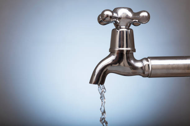 istock clean water is poured into a glass from the tap 671200878
