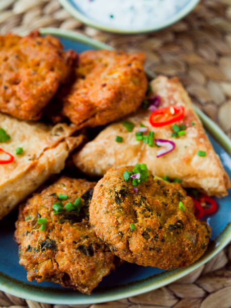 istock Indian Samosa, Pakora, Bhaji with Garlic Naan Bread, Raita. 671203626