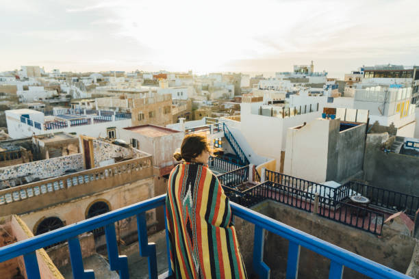 Woman looking at view from roof in Essaouria Young Caucasian woman looking at  scenic view from roof in Essaouria essaouira stock pictures, royalty-free photos & images