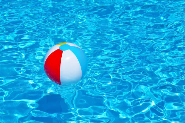 istock Colorful inflatable ball floating in swimming pool 671207112