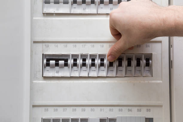 istock Man's finger checking an electricity in the fuse box. Dangerous activity. Indoor. 671207786