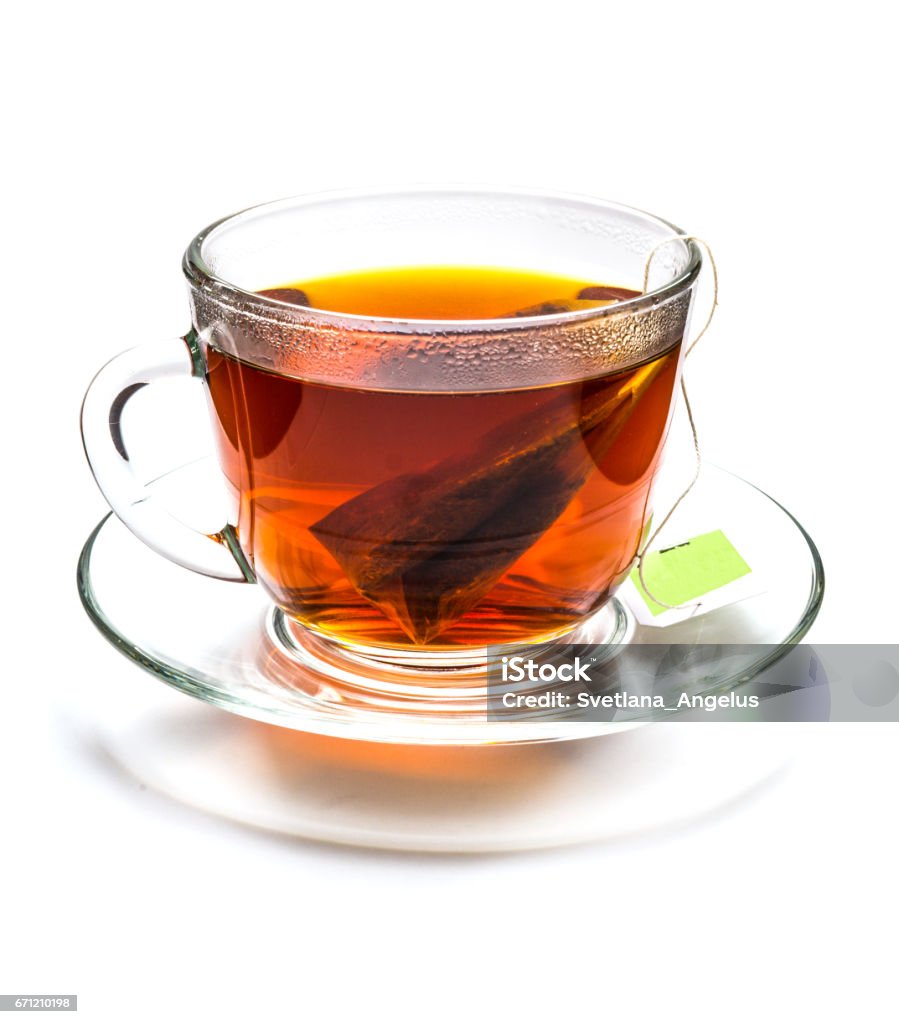 Cup of tea with tea bag isolated on white Transparent cup of black tea with tea bag isolated on white background Tea - Hot Drink Stock Photo