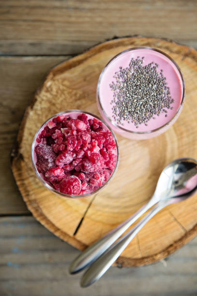 istock Chia raspberies cottage cheese breakfast in two small transparent glasses 671210756
