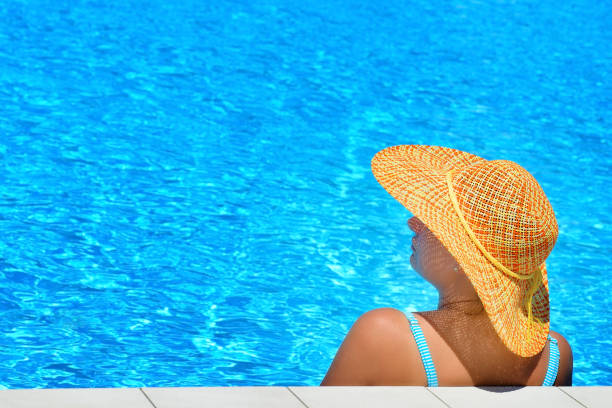istock Real female beauty relaxing at swimming pool 671210910