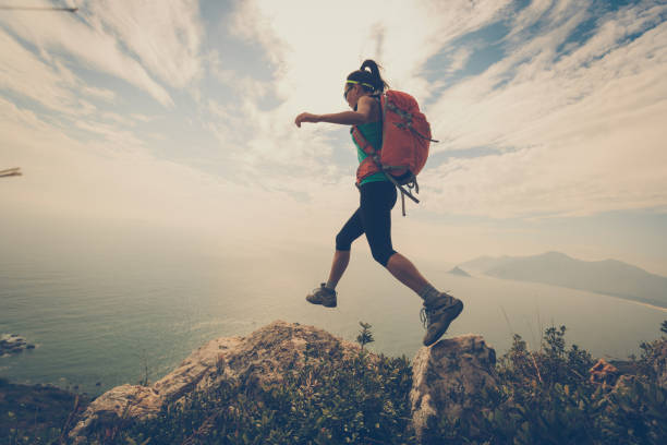 istock successful woman hiker hiking on mountain peak 671211380