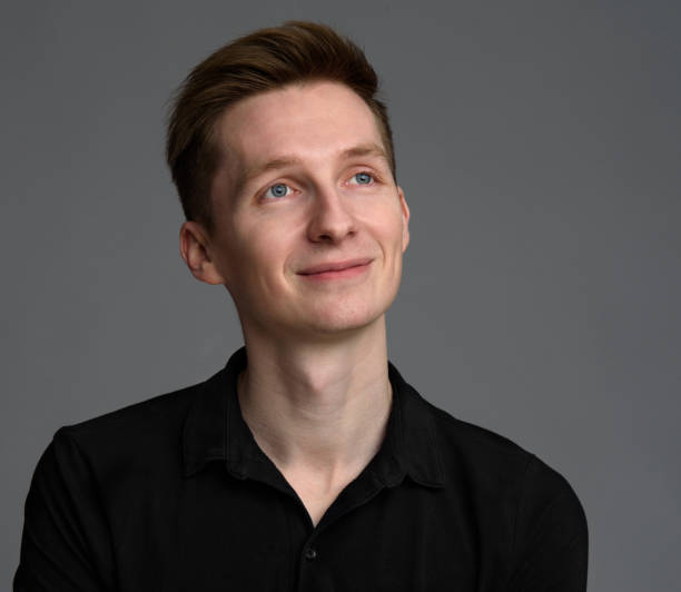 istock casual handsome young man looking up 671211382