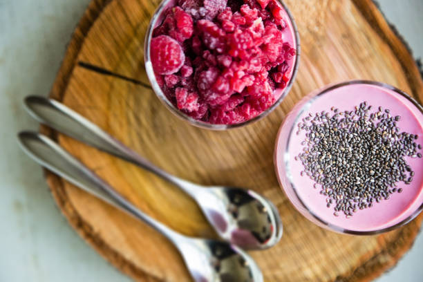 istock Chia raspberies cottage cheese breakfast in two small transparent glasses 671213380