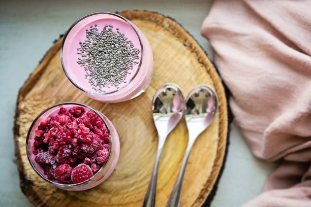 istock Chia raspberies cottage cheese breakfast in two small transparent glasses 671216492