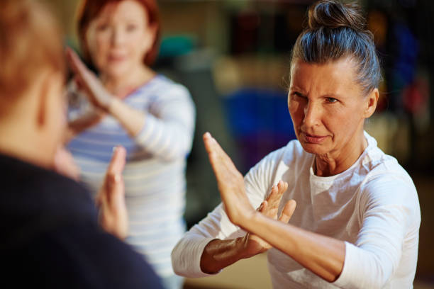Battle exercise Mature fighter repeating after her instructor self defense stock pictures, royalty-free photos & images
